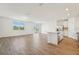 Open-concept living area with tile floors, connecting the kitchen and living spaces at 1124 Griffon Ave, Lake Alfred, FL 33850