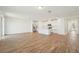 Open-concept living space with wood-look tile floors, a kitchen island, and stainless steel appliances at 1124 Griffon Ave, Lake Alfred, FL 33850