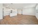 Light-filled living area featuring sleek floors, an open layout with a kitchen island, and modern white cabinetry at 1124 Griffon Ave, Lake Alfred, FL 33850