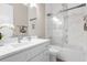 Elegant bathroom with a sleek vanity, modern fixtures, and a glass-enclosed tub/shower at 12608 Ne 49Th Dr, Oxford, FL 34484