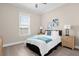 Bright bedroom featuring a queen bed, stylish nightstands, and soothing wall art at 12608 Ne 49Th Dr, Oxford, FL 34484
