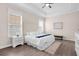 Serene bedroom with tray ceiling, natural light, and calm neutral decor, with hard surface flooring at 12608 Ne 49Th Dr, Oxford, FL 34484