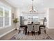 Elegant dining room with chandelier lighting, neutral decor, and open layout to bright kitchen and living areas at 12608 Ne 49Th Dr, Oxford, FL 34484