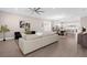 Spacious living room with a large sectional, neutral decor, and open layout to dining and kitchen area at 12608 Ne 49Th Dr, Oxford, FL 34484