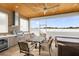 This outdoor kitchen features modern appliances, grill, beverage center, and a dining set for luxury outdoor living at 12608 Ne 49Th Dr, Oxford, FL 34484