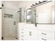 Modern bathroom featuring a glass shower and a white vanity with black hardware at 14480 Chinese Elm Dr, Orlando, FL 32828