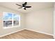 Bright bedroom with hardwood floors, a ceiling fan, and a large window at 14480 Chinese Elm Dr, Orlando, FL 32828