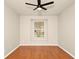 Cozy bedroom with hardwood floors, a ceiling fan, and a window at 14480 Chinese Elm Dr, Orlando, FL 32828