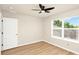Bedroom featuring a ceiling fan, neutral walls, wood-look flooring and a large window at 14480 Chinese Elm Dr, Orlando, FL 32828