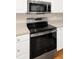 Sleek kitchen with stainless steel appliances and white cabinetry offers a clean aesthetic at 14480 Chinese Elm Dr, Orlando, FL 32828