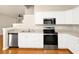 Stylish kitchen featuring white cabinets and stainless steel appliances, perfect for cooking at 14480 Chinese Elm Dr, Orlando, FL 32828