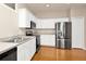 Modern kitchen boasts white cabinets, stainless steel appliances, and ample counter space at 14480 Chinese Elm Dr, Orlando, FL 32828