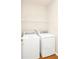 Laundry room featuring a full-size, white washer and dryer and wire shelving at 14480 Chinese Elm Dr, Orlando, FL 32828