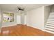 Inviting living room featuring wood floors, stairs, and a view, blending comfort and style at 14480 Chinese Elm Dr, Orlando, FL 32828