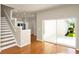 Open-concept living room with staircase flowing into kitchen, creating a modern feel at 14480 Chinese Elm Dr, Orlando, FL 32828