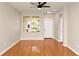 Bright living room boasts hardwood floors, a ceiling fan, and natural light, ideal for gatherings at 14480 Chinese Elm Dr, Orlando, FL 32828