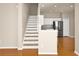 Open-concept living area showcasing stairs and kitchen with modern appliances at 14480 Chinese Elm Dr, Orlando, FL 32828