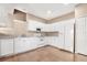 Well-equipped kitchen featuring white cabinetry and hardwood floors at 14480 Chinese Elm Dr, Orlando, FL 32828