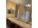 Bathroom featuring double sinks, granite counters, and large mirror at 2355 Abalone Blvd, Orlando, FL 32833