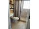 Bathroom featuring a toilet, shower with glass door, tiled floor, and neutral-colored walls at 2355 Abalone Blvd, Orlando, FL 32833