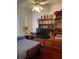 Cozy bedroom featuring hardwood floors, a ceiling fan, and a built-in bookcase with storage at 2355 Abalone Blvd, Orlando, FL 32833