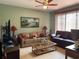 Inviting living room area featuring art on the walls, a ceiling fan, and comfortable seating at 2355 Abalone Blvd, Orlando, FL 32833