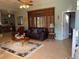 Bright living room with tan tile floors, area rug, and sliding glass doors leading to patio at 2355 Abalone Blvd, Orlando, FL 32833