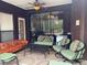Cozy screened patio with comfortable seating, a ceiling fan, and a view of the outdoor pool at 2355 Abalone Blvd, Orlando, FL 32833