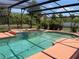 Large screened-in pool with spa surrounded by tropical landscaping and a spacious patio at 2355 Abalone Blvd, Orlando, FL 32833