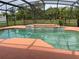 Enclosed pool area with a pool, spa, and tropical vegetation, creating a private oasis at 2355 Abalone Blvd, Orlando, FL 32833