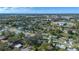 Aerial view of a residential neighborhood showing houses, trees, and a glimpse of a town at 5533 Satel Dr, Orlando, FL 32810