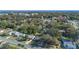 Aerial view of a residential area, showing houses surrounded by mature trees at 5533 Satel Dr, Orlando, FL 32810