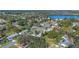 Aerial view of a neighborhood near a lake, featuring various houses and landscaping at 5533 Satel Dr, Orlando, FL 32810