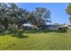 Large backyard with mature trees and grassy area at 5533 Satel Dr, Orlando, FL 32810