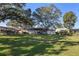 Spacious backyard with large trees and a pergola at 5533 Satel Dr, Orlando, FL 32810