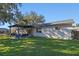 Home's back with pergola, patio furniture, and grassy yard at 5533 Satel Dr, Orlando, FL 32810