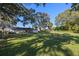 Expansive backyard with lush grass and large trees at 5533 Satel Dr, Orlando, FL 32810