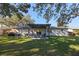 Home's back with pergola, patio furniture, and grassy yard at 5533 Satel Dr, Orlando, FL 32810