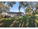 Home's back with pergola, patio furniture, and grassy yard at 5533 Satel Dr, Orlando, FL 32810