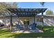 Relaxing backyard patio with pergola cover, comfortable seating, and paver stones at 5533 Satel Dr, Orlando, FL 32810