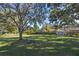Backyard with picnic table, large trees, and shed at 5533 Satel Dr, Orlando, FL 32810