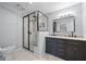 Modern bathroom with a double vanity and walk-in shower at 5533 Satel Dr, Orlando, FL 32810