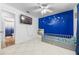 bedroom with blue walls, twin bed, and built-in shelves at 5533 Satel Dr, Orlando, FL 32810
