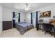 Bedroom with a workspace and striped bedding at 5533 Satel Dr, Orlando, FL 32810