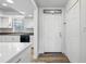 Bright entryway with white door and wood-look flooring at 5533 Satel Dr, Orlando, FL 32810