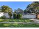 Single story house with a white garage door and manicured lawn at 5533 Satel Dr, Orlando, FL 32810