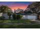 Charming single-story home with a well-maintained lawn and attached garage at 5533 Satel Dr, Orlando, FL 32810