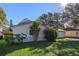 Side view of a house with a lush green lawn at 5533 Satel Dr, Orlando, FL 32810