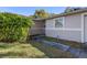 Home's entrance with a black door and walkway at 5533 Satel Dr, Orlando, FL 32810