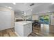 Kitchen island with white cabinets and hardwood floors at 5533 Satel Dr, Orlando, FL 32810